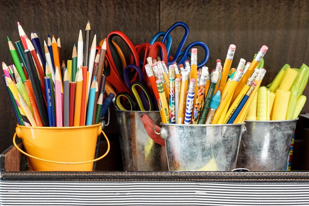 cups of pencils, pens and scissors